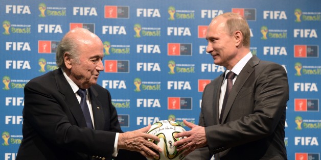 FILE - In this file photo taken on Sunday, July 13, 2014, FIFA President Sepp Blatter, left, and Russian President Vladimir Putin hold a soccer ball during the official ceremony of handover to Russia as the 2018 World Cup hosts, after the World Cup final soccer match between Germany and Argentina at the Maracana Stadium in Rio de Janeiro. Russian football is plagued by a racist and far-right extremist fan culture that threatens the safety of visitors to the 2018 World Cup, a dossier provided to The Associated Press revealed on Friday, Feb. 27, 2015. Researchers from the Moscow-based SOVA Center and the Fare network, which helps to prosecute racism cases for UEFA, cataloged more than 200 cases of discriminatory behavior linked to Russian football across two seasons.(AP Photo/RIA-Novosti, Alexei Nikolsky, Presidential Press Service, File)