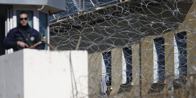 A police officer stands guard at Korydallos Prison, in western Athens, on Friday, Nov. 21, 2014. Prisoners and authorities say inmates in the prison hospital of Korydallos, Greeceâs largest penitentiary, have gone on a rampage, smashing parts of the facilityâs ground floor. Local media said the rioting began Friday morning after a visitor was detained for allegedly attempting to smuggle drugs. (AP Photo/Petros Giannakouris)
