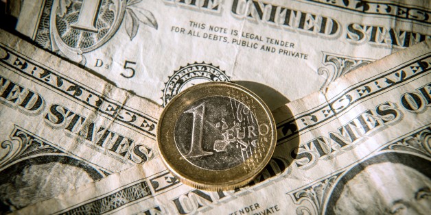 A one euro coin is pictured on one US dollar notes on March 13, 2015 in Godewaersvelde, Northern France. AFP PHOTO / PHILIPPE HUGUEN (Photo credit should read PHILIPPE HUGUEN/AFP/Getty Images)