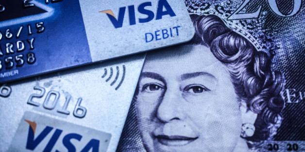 BRISTOL, ENGLAND - MAY 21: In this photo illustration a credit card is seen on top of cash on May 21, 2015 in Bristol, England. Cashless payments have overtaken the use of use notes and coins for the first time according to the Payments Council. (Photo illustration by Matt Cardy/Getty Images)