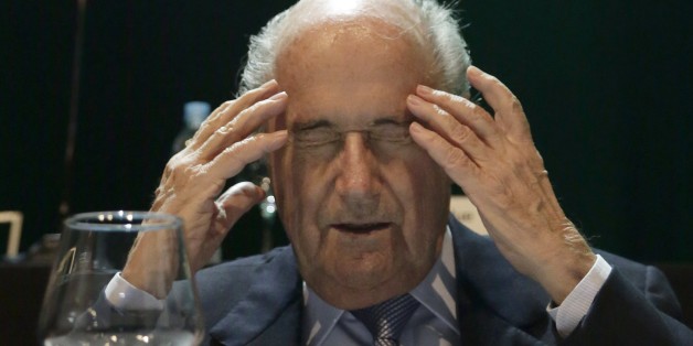 In this Wednesday, March 4, 2015 photo, FIFA President Sepp Blatter closes his eyes as he raises his hands to his temples during a CONMEBOL congress in Asuncion, Paraguay. The 78-year-old Blatter is seeking a fifth, four-year term running football. (AP Photo/Jorge Saenz)