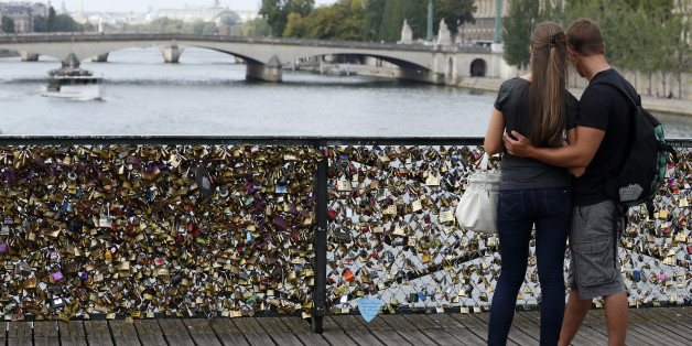 TO GO WITH AFP STORY BY BONIFACE MURUTAMPUNZI
A couple looks at the Pont des Arts where padlocks are attached to the railing, on August 30, 2013 in Paris. Due to security reason authorities consider removing the 'Love locks' that have been attached to the Pont des Arts bridge since 2008 by thousand of lovers.AFP PHOTO / PATRICK KOVARIK (Photo credit should read PATRICK KOVARIK/AFP/Getty Images)
