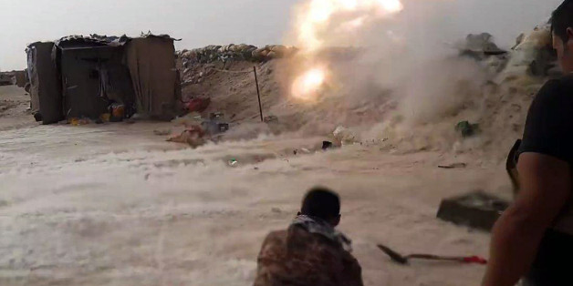 In this image taken Friday, May 29, 2015, Iraqi anti-terrorism forces battle with Islamic State group extremists as they defend their base against Islamic State group extremist attack outside Fallujah, 40 miles (65 kilometers) west of Baghdad, Iraq. (AP Photo)