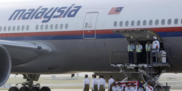 Malaysian Army soldiers carry a coffin containing the body of Mohd Ghafar Abu Bakar, a Malaysia Airlines in-flight supervisor who was among the victims on board Flight MH17, upon arrival at Kuala Lumpur International Airport in Sepang, Malaysia, Sunday, Aug. 24, 2014. (AP Photo/Lai Seng Sin)
