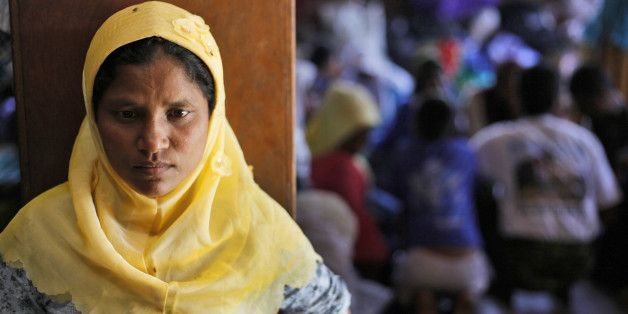 A Rohingya woman stands at a temporary shelter in Bayeun, Aceh Province, Indonesia, Monday, June 1, 2015. Since early May, thousands of boat people from Myanmar and Bangladesh have been brought ashore from Southeast Asian waters. Several thousand more are believed to still be at sea after human smugglers abandoned their boats amid a regional crackdown. (AP Photo/Binsar Bakkara)