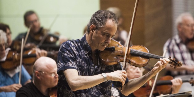 In this photo taken Wednesday, May 27, 2015, Grammy Award-winning American violinist Eugene Drucker, plays his violin during a rehearsal concert at the Music Hall in Raanana, central Israel. In 1933, the violinist Ernest Drucker left the stage midway through a Brahms concerto in Cologne at the behest of Nazi officials, in one of the first anti-Semitic acts of the new regime. Now, more than 80 years later, his son, Eugene, has completed his fatherâs interrupted work. With tears in his eyes,