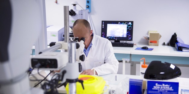 A forensic scientist of the Criminal Research Institute of the National Gendarmerie (IRCGN), looks through a microscope, on May 19, 2015 in Pontoise, outside Paris. A scanner for autopsies, a collection of 8,000 weapons, 'data-gendarmes' to predict the evolution of delinquency: the gendarmerie includes hundreds of 'experts' in a brand new judicial center in the Val-d'Oise. AFP PHOTO MARTIN BUREAU (Photo credit should read MARTIN BUREAU/AFP/Getty Images)
