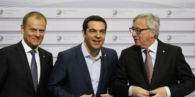 European Commission President Jean-Claude Juncker, right, and Greek Prime Minister Alexis Tsipras, center, button their jackets as the stand with European Council President Donald Tusk during arrivals at the Eastern Partnership summit in Riga, on Friday, May 22, 2015. EU leaders gather for a second day of meetings with six post-communist nations to discuss various issues, including enlargement, the economy and Ukraine. (AP Photo/Mindaugas Kulbis)