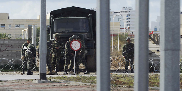 Soldiers control a district of Tunis, Thursday Jan. 13, 2011. Sporadic sounds of clashes and rounds of gunfire echoed in the suburbs of Tunisia's capital early Thursday as youths defied a government curfew order aimed at calming more than three weeks of riots by protesters angry about high unemployment. (AP Photo/Hedi Ben Salem)