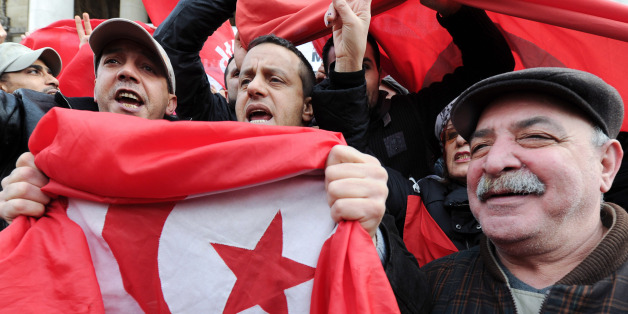 Tunisians living in Belgium protest against Tunisia's President Zine Abidine El Ben Ali at the Brussels' stock market, Saturday Jan. 15, 2011. Tunisia has been grappling with looting, deadly fires and widespread unrest after protests forced President Zine El Abidine Ben Ali to flee to Saudi Arabia on Friday. (AP Photo/Geert Vanden Wijngaert)