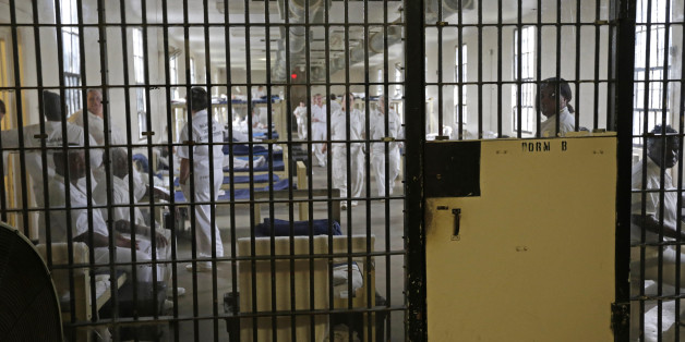 FILE - In this Monday, Sept. 23, 2013, file photo, inmates sit in their bunks in Dorm B at Tutwiler Prison for Women in Wetumpka, Ala. On Thursday, May 28, 2015, the Justice Department filed both a civil lawsuit against the state and a settlement agreement to address the alleged abuses at the Julia Tutwiler Prison for Women. State officials have agreed to install monitoring cameras, increase privacy in bathrooms, hire more staff and implement new procedures to ensure inmate complaints are taken