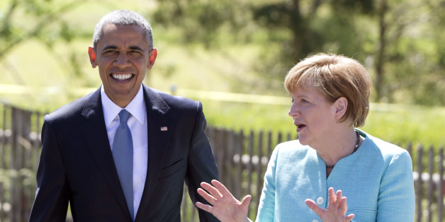 US President Barack Obama and German Chancellor Angela Merkel walk together as the president arrives in Kruen, near Garmisch-Partenkirchen, southern Germany, Sunday, June 7, 2015, before attending the G-7 summit in Schloss Elmau hotel. (AP Photo/Carolyn Kaster)