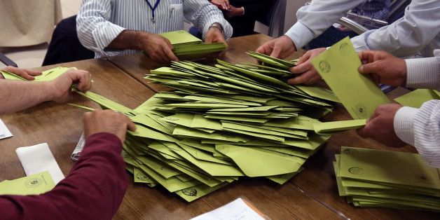 Polling station officials count the ballots, in Ankara, Turkey, Sunday, June 7, 2015. Turks are heading to the polls in a crucial parliamentary election that will determine whether ruling party lawmakers can rewrite the constitution to bolster the powers of Erdogan. All eyes will be on the results for the main Kurdish party, the Kurdish Peoples' Democratic Party, (HDP). If it crosses a 10 percent threshold for entering parliament as a party, that would extinguish ruling AKP's constitutional plan