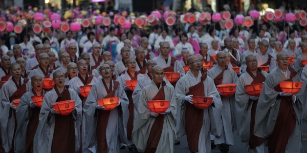 Buddhist monks carry lanterns in a parade during the Lotus Lantern Festival to celebrate the upcoming birthday of Buddha on May 28, on a street in Seoul, South Korea, Sunday, May 19, 2012. (AP Photo/Ahn Young-joon)