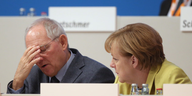 COLOGNE, GERMANY - DECEMBER 10: German Chancellor and Chairwoman of the German Christian Democrats (CDU) Angela Merkel (R) and German Finance Minister Wolfgang Schaeuble chat at the annual CDU party congress on December 10, 2014 in Cologne, Germany. The CDU is the senior partner in Germany's ruling government coalition and yesterday delegates re-elected Merkel as party chairwoman with 96.7% of votes. (Photo by Sean Gallup/Getty Images)