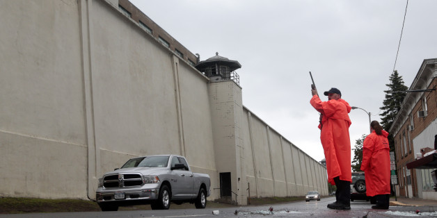 A state corrections officer monitors traffic passing Clinton Correctional Facility on Monday, June 8, 2015, in Dannemora, N.Y. Two murderers who escaped from the prison by cutting through steel walls and pipes remain on the loose Monday as authorities investigate how the inmates obtained the power tools used in the breakout. (AP Photo/Mike Groll)