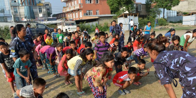 Nepalese police officers conduct a self defence training session for women and childeren at a shelter for earthquake victims in Kathmandu on June 5, 2015. A cycle of unemployment and poverty, and the impact of a 10-year Maoist insurgency has made Nepalese women and children easy targets for traffickers, and campaigners say that the April 2015 earthquake increased the threat. AFP PHOTO / Prakash MATHEMA (Photo credit should read PRAKASH MATHEMA/AFP/Getty Images)