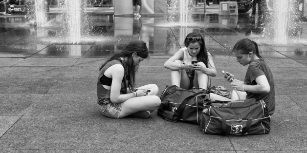 A few young women sit on the ground in Dundas Square using their cell phones. Yonge and Dundas Square
More at:
<a href="http://www.OrangeGreenBlue.net" rel="nofollow">www.OrangeGreenBlue.net</a>