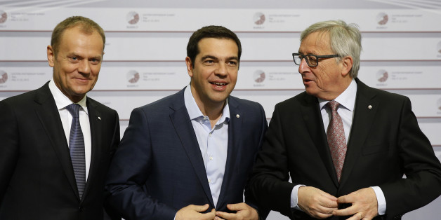 European Commission President Jean-Claude Juncker, right, and Greek Prime Minister Alexis Tsipras, center, button their jackets as the stand with European Council President Donald Tusk during arrivals at the Eastern Partnership summit in Riga, on Friday, May 22, 2015. EU leaders gather for a second day of meetings with six post-communist nations to discuss various issues, including enlargement, the economy and Ukraine. (AP Photo/Mindaugas Kulbis)