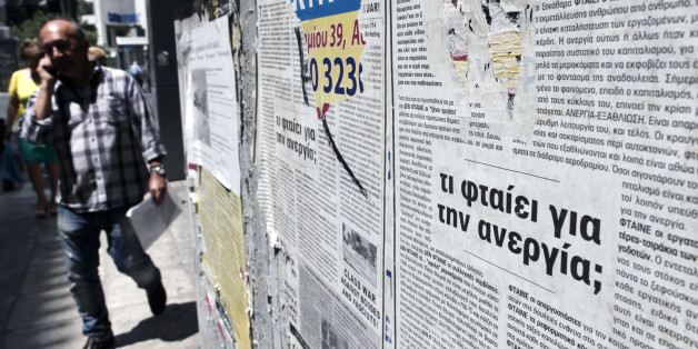 A poster reads "Why unemployment (is high)?'' outside an office of the Labor Force Employment Organization (OAED) in central Athens, Thursday, June 6, 2013. Unemployment in recession-mired Greece continued its record-setting rise in March, reaching 26.8 percent of the workforce compared to a revised 26.7 percent a month earlier. (AP Photo/Petros Giannakouris)