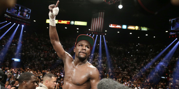Floyd Mayweather Jr. celebrates his WBC-WBA welterweight title boxing fight victory over Marcos Maidana Saturday, May 3, 2014, in Las Vegas. (AP Photo/Eric Jamison)