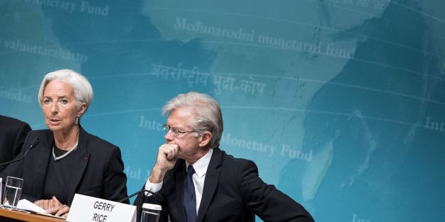 IMF Western Hemisphere Director Alejandro Werner (L) and spokesperson Gerry Rice (R) listen while IMF Managing Director Christine Lagarde speaks to the press at the International Monetary Fund's headquarters June 16, 2014 in Washington, DC. Lagarde and others spoke about the IMF's annual check-up of the US economy. AFP PHOTO/Brendan SMIALOWSKI (Photo credit should read BRENDAN SMIALOWSKI/AFP/Getty Images)