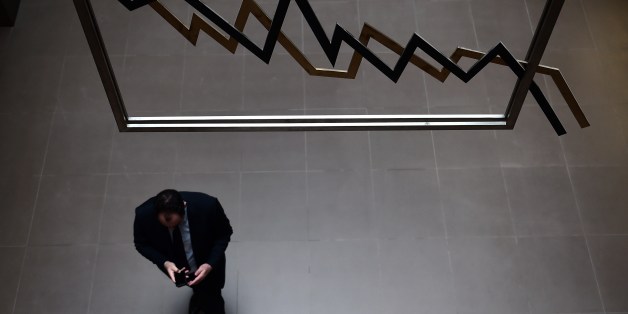 An employee walks at the Athens stock exchange on April 10, 2014. A milestone Greek bond sale, marking the country's return to the medium-term market after four years, was 'at least eight times oversubscribed,' the country's deputy PM said on Thursday. European stocks fell on Thursday as investors shrugged off a successful return to the bond markets by Greece four years after the country was rescued with a bailout. AFP PHOTO / ARIS MESSINIS (Photo credit should read ARIS MESSINIS/AFP/Getty Images)