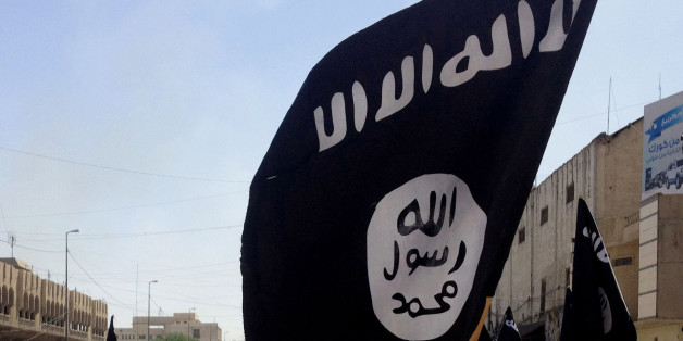 FILE - In this Monday, June 16, 2014 file photo, demonstrators chant pro-Islamic State group slogans as they wave the group's flags in front of the provincial government headquarters in Mosul, 225 miles (360 kilometers) northwest of Baghdad, Iraq. (AP Photo, File)