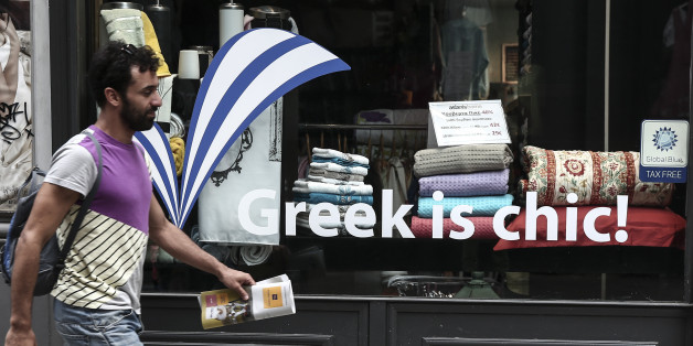 A man walks past a shop window in Athens, Greece, on Sunday, June 7, 2015. Greece cannot accept the "irrational" proposal made this week by its bailout creditors, Prime Minister Alexis Tsipras told an emergency Parliament session Friday, adding that any deal must also include some lightening of the country's crushing debt load. (AP Photo/Yorgos Karahalis)
