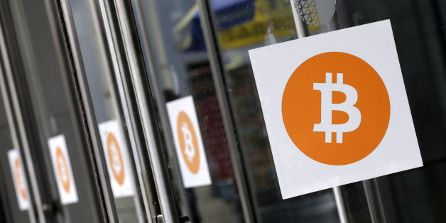 Bitcoin logos are displayed at the Inside Bitcoins conference and trade show, Monday, April 7, 2014 in New York. Bitcoin users exchange cash for digital money using online exchanges, then store it in a computer program that serves as a wallet. The program can transfer payments directly to merchants or individuals around the world, eliminating transaction fees and the need for bank or credit card information. (AP Photo/Mark Lennihan)
