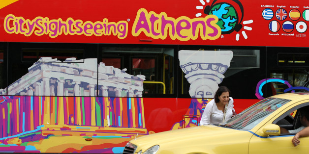A commuter tries to stop a taxi at the Athens' main Syntagma square during a work stoppage by public transport employees on Wednesday, Sept. 29, 2010. Bus and trolley drivers walked off the job for several hours while Athens' metro system and tram were to shut down at noon. National railway workers were also walking off the job at noon, disrupting rail connections across the country, while doctors at state hospitals were on a 24-hour strike. (AP Photo/Thanassis Stavrakis)