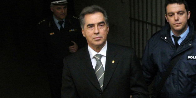 FILE - In this Wednesday, Feb, 27, 2013 file photo, Vassilis Papageorgopoulos, the former mayor of Greeceâs second largest city, Thessaloniki, is escorted by police after appearing in court in the city . On appeal, the court on Monday, July 17, 2014, reduced his prison sentence from life to 12 years, after he was found guilty of embezzling more than â¬17 million ($23 million) in city funds. Papageorgopoulos, a 67-year-old former champion sprinter, was mayor from 1999-2010, and the corru