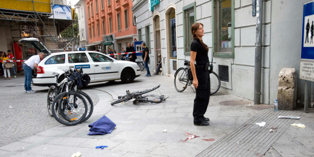 A danaged bicycle and bloodstains are pictured at the site where a man drove his van into a crowd in Graz, southern Austria, Saturday, June 20, 2015. Police confirmed the incident but would not give any details or confirm the number of dead and injured persons. (Elmar Gubisch/APA via AP)