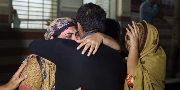 Relatives mourn the death of a heatwave victim at the EDHI morgue in Karachi on June 21, 2015. A heatwave has killed at least 45 people in Pakistan's largest city of Karachi, officials said June 21, as residents grapple with frequent power outages and water scarcity during the Muslim fasting month of Ramadan. AFP PHOTO / ASIF HASSAN (Photo credit should read ASIF HASSAN/AFP/Getty Images)