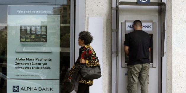 A man uses an ATM outside a bank in Athens, Friday, June 19, 2015. Several European countries said openly they are getting ready for the possibility of Greece leaving the euro. And though there was no sign of panic in the streets of Greece over that prospect, officials say Greeks are taking money out of banks in growing amounts. (AP Photo/Thanassis Stavrakis)