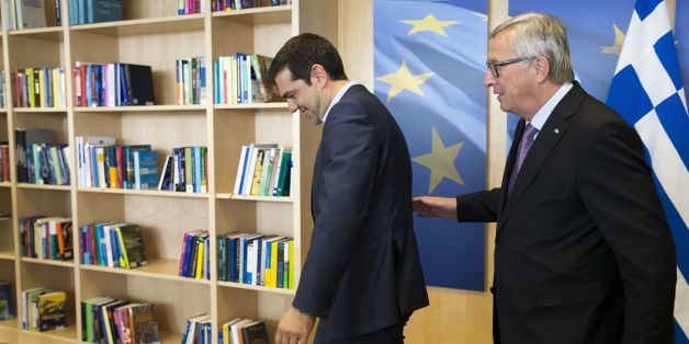 Greece's Prime Minister Alexis Tsipras (L) is welcomed by European Commission President Jean-Claude Juncker (R) ahead of a meeting on Greece, at the European Commission in Brussels,on June 24, 2015, as eurozone finance ministers try to finalise a debt deal and avoid a default by Athens. Greek Prime Minister Alexis Tsipras is set to conduct yet another round of crisis talks with representatives of the country's creditors, ahead of a crucial meeting of eurozone finance ministers where all sides ho