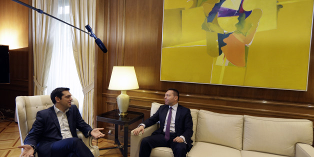 Greece's Prime Minister Alexis Tsipras, left, speaks with Governor of the Bank of Greece Yannis Stournaras at Maximos Mansion in Athens, Friday, March 6, 2015. European Central Bank head Mario Draghi said the ECB "stood ready" to once again permit Greek banks to use junk-rated Greek government bonds as collateral to get credit from the ECB. That would happen as soon as the bank assesses that Greece is likely to successfully complete a creditor review of its progress. (AP Photo/Thanassis Stavrakis)