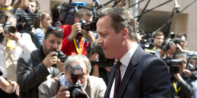 British Prime Minister David Cameron walks by the media as he arrives for an EU summit in Brussels on Thursday, June 25, 2015. Greece and its creditors launched a new round of talks in Brussels early Thursday in a fresh bid to unlock billions of euros in loans and save the country from bankruptcy. (AP Photo/Virginia Mayo)