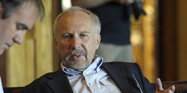 Ewald Novotny, governor of the Central Bank of Austria, talks with a reporter during a break from the morning session of the Economic Policy Symposium at Jackson Hole in Moran, Wyo., Friday, Aug. 26, 2011. (AP Photo/Reed Saxon)