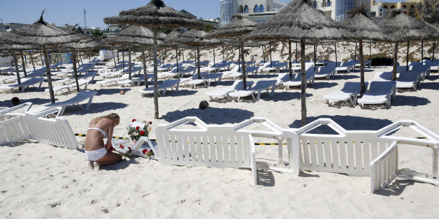 A ypong woman lays a flowers at the scene of a shooting in Sousse, Tunisia, Saturday, June 27, 2015. The morning after a lone gunman killed at tens of people at a beach resort in Tunisia, busloads of tourists are heading to the nearby Enfidha-Hammamet airport hoping to return to their home countries. (AP Photo/Darko Vojinovic)