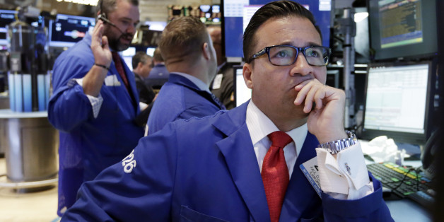 Specialist Paul Corsentino, right, works at his post on the floor of the New York Stock Exchange Wednesday, June 17, 2015. Investors are waiting for a policy statement from the Fed that could indicate if it is moving closer to raising its benchmark interest rate. (AP Photo/Richard Drew)