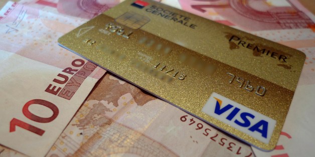 A credit card is pictured on ten euros notes on July 8, 2014 in Lille. AFP PHOTO / DENIS CHARLET (Photo credit should read DENIS CHARLET/AFP/Getty Images)