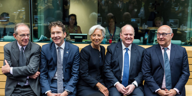 Managing Director of the International Monetary Fund Christine Lagarde, center, talks with Dutch Finance Minister and chair of the eurogroup Jeroen Dijsselbloem, second left, Italy's Finance Minister Pier Carlo Padoan, left, Ireland's Finance Minister Michael Noonan, second right, and France's Finance Minister Michel Sapin during a meeting of eurozone finance ministers in Brussels on Thursday, June 25, 2015. Greece and its creditors launched a new round of talks in Brussels early Thursday in a fresh bid to unlock billions of euros in loans and save the country from bankruptcy. (AP Photo/Geert Vanden Wijngaert)