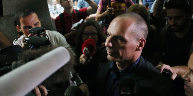Greece's Finance Minister Yanis Varoufakis surrounded by media as he arrives for a meeting with heads of the Greek banks at the Finance Ministry in Athens, Sunday, June 28, 2015. The European Central Bank refused to increase emergency credit to Greek banks on Sunday, a day after the government threw Greece's bailout negotiations into turmoil by calling a referendum on creditors' financial proposals. (AP Photo/Petros Karadjias)