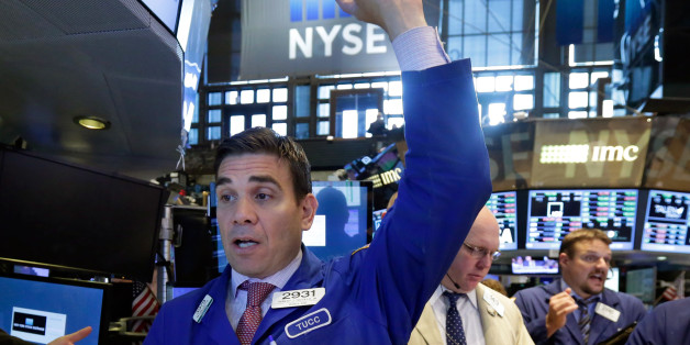 Specialist Robert Tuccillo, left, works at his post on the floor of the New York Stock Exchange, Tuesday, June 30, 2015. U.S. stocks are rising broadly in early trading as investors hope for a last-minute deal on Greece's debt woes. (AP Photo/Richard Drew)