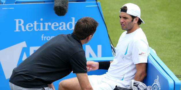 NOTTINGHAM, ENGLAND - JUNE 22: Malek Jaziri of Tunisia receives treatment in his match against Kyle Edmund of Great Britain on day two of the Aegon Open Nottingham at Nottingham Tennis Centre on June 22, 2015 in Nottingham, England. (Photo by Jan Kruger/Getty Images for LTA)