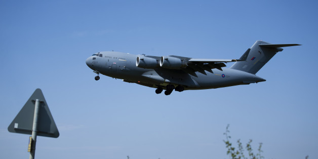 A plane repatriating some of the British victims of the Tunisia beach attack comes in to land at the RAF (Royal Air Force) Brize Norton base in Brize Norton, England, Wednesday, July 1, 2015. Britain on Wednesday began repatriating the remains of victims of last week's terror attack at a Tunisian beach resort. (AP Photo/Matt Dunham)