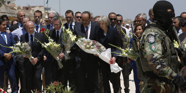 British Home Secretary Theresa May centre right, French Interior Minister Bernard Cazeneuve 2nd left, German Interior Minister Thomas de Maiziere 3rd left joined their Tunisian counterpart Mohamed Najem Gharsalli centre, on the beach in front of the Imperial Marhaba hotel in the Mediterranean resort of Sousse for a tribute in Sousse, Tunisa, Monday, June 29, 2015. The top security officials of Britain, France, Germany and Belgium are paying homage to the people killed in the terrorist attack