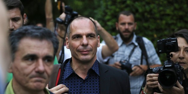 Greece's Finance Minister Yanis Varoufakis, center, and Deputy Foreign Minister for international economic relations, Euclid Tsakalotos, left, arrive for an urgent cabinet meeting at Maximos Mansion in Athens, Sunday, June 28, 2015. Greek Prime Minister Alexis Tsipras says the Bank of Greece has recommended that banks remain closed and restrictions be imposed on transactions, after the European Central Bank didn't increase the amount of emergency liquidity the lenders can access from the centra