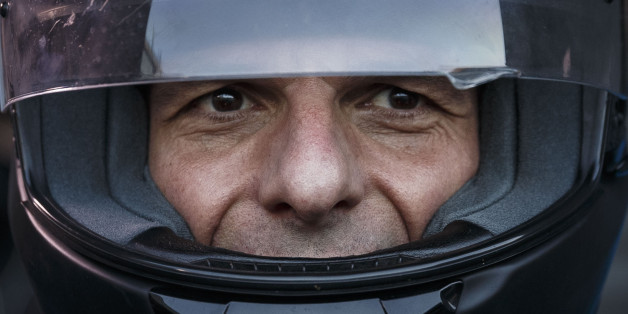 Greece's Finance Minister Yanis Varoufakis puts on his motorbike helmet as he leaves his office in Athens, Wednesday, July 1, 2015. About 1,000 bank branches around the country were ordered by the government to reopen Wednesday to help desperate pensioners without ATM cards cash up to 120 euros ($134) from their retirement checks. Eurozone finance ministers were set to weigh Greece's latest proposal for aid Wednesday. (AP Photo/Daniel Ochoa de Olza)